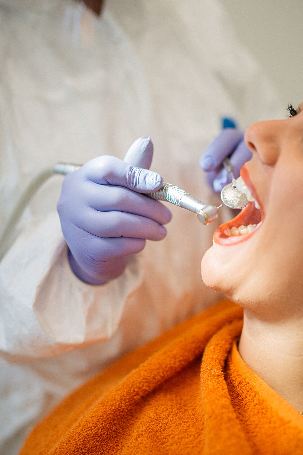 Dentist adjusting a patient's braces